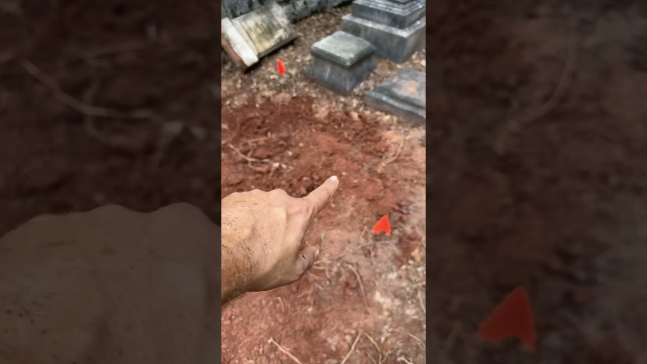 Uncovering a grave stone covered up by grave robbers 