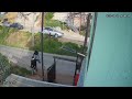 Pedestrian Trips Over Low Barrier on Street