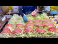 japanese street food - okonomiyaki with huge pork slice お好み焼き