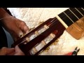 Winding strings on a slotted peghead  restringing a classical guitar