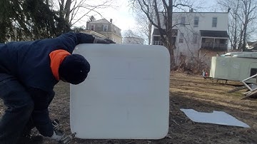 IBC tote tank made into a firewood stack cover