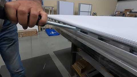 Pounding the Facid clips on the PVC mesh into the Facid frame - 100" example