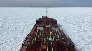 Ship moving through ice (Frozen Sea) in North Atlantic ocean