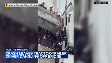 Tractor-trailer driver rescued from cab dangling off bridge in West Virginia