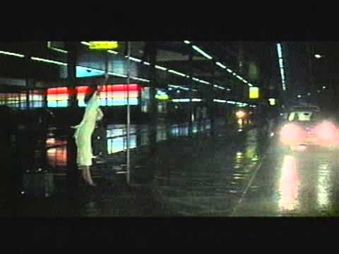 Woman in a rainstorm at an airport