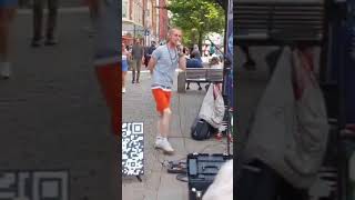 Incredible white man busking on the streets of Manchester to reggae music.