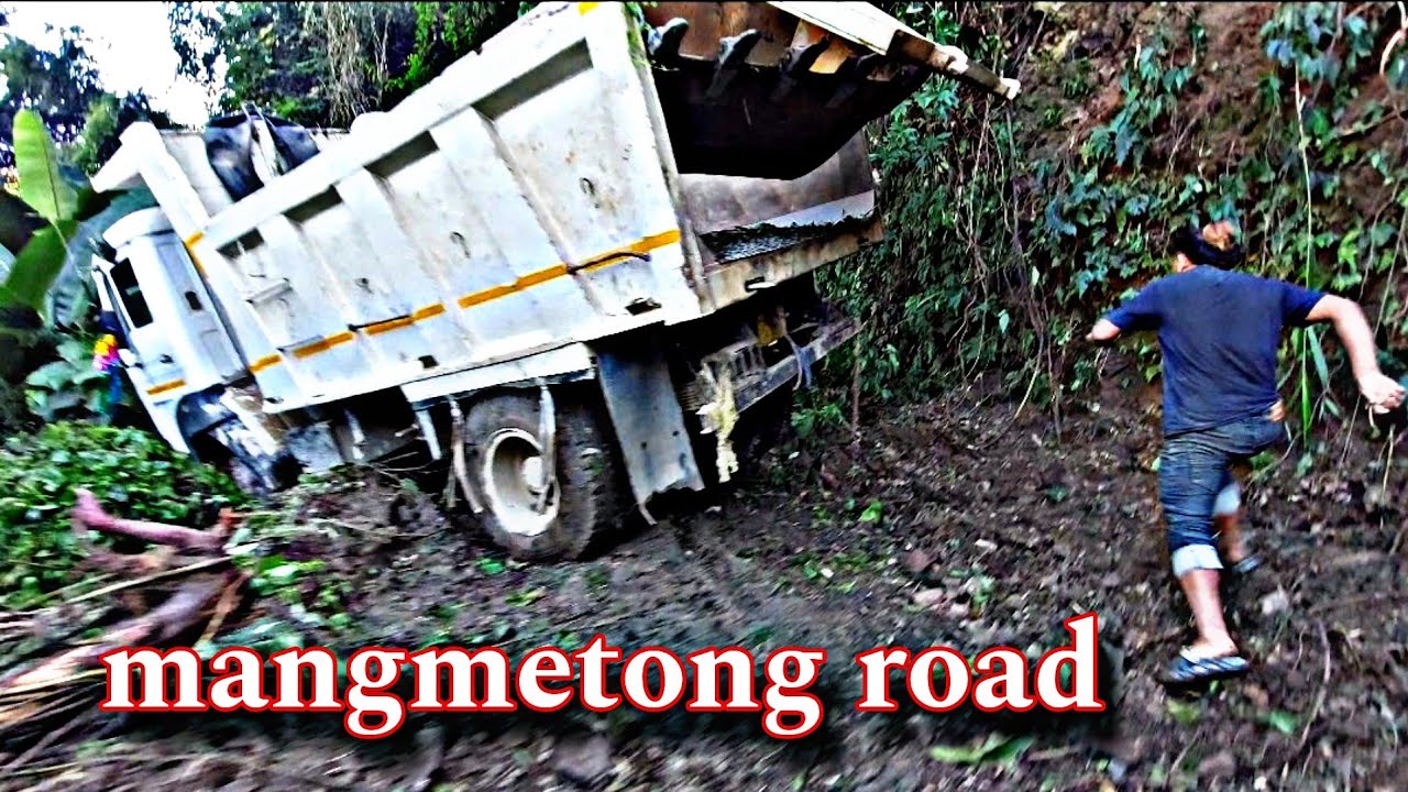 tipper truck stuck badly in mangmetong road rescue by excavator.