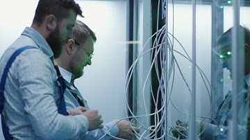 Male IT Technicians Fitting Servers Stock Video