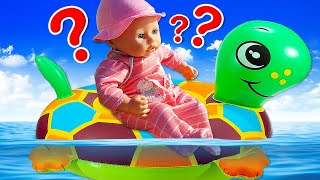 A new toy for the baby doll at the swimming pool. Baby Annabell doll feeds turtles at the beach.