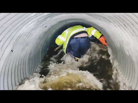 Unclogging Culvert To Drain Roadway