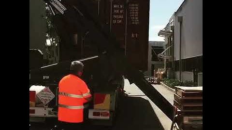 How to unload a shipping container from a side loader truck