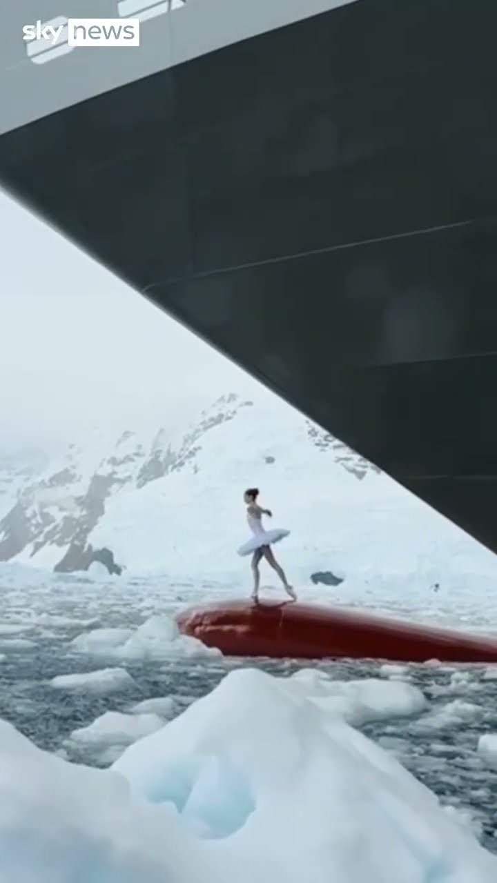 Ballerina dances on top of ship's bow