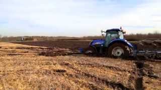 A New Holland T6080 gets stuck whilst ploughing.