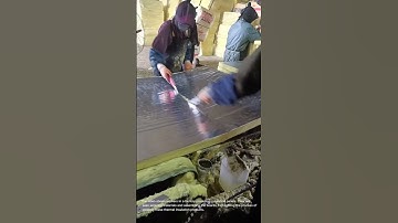 Insulation Panel Production: Workers Crafting Thermal Boards