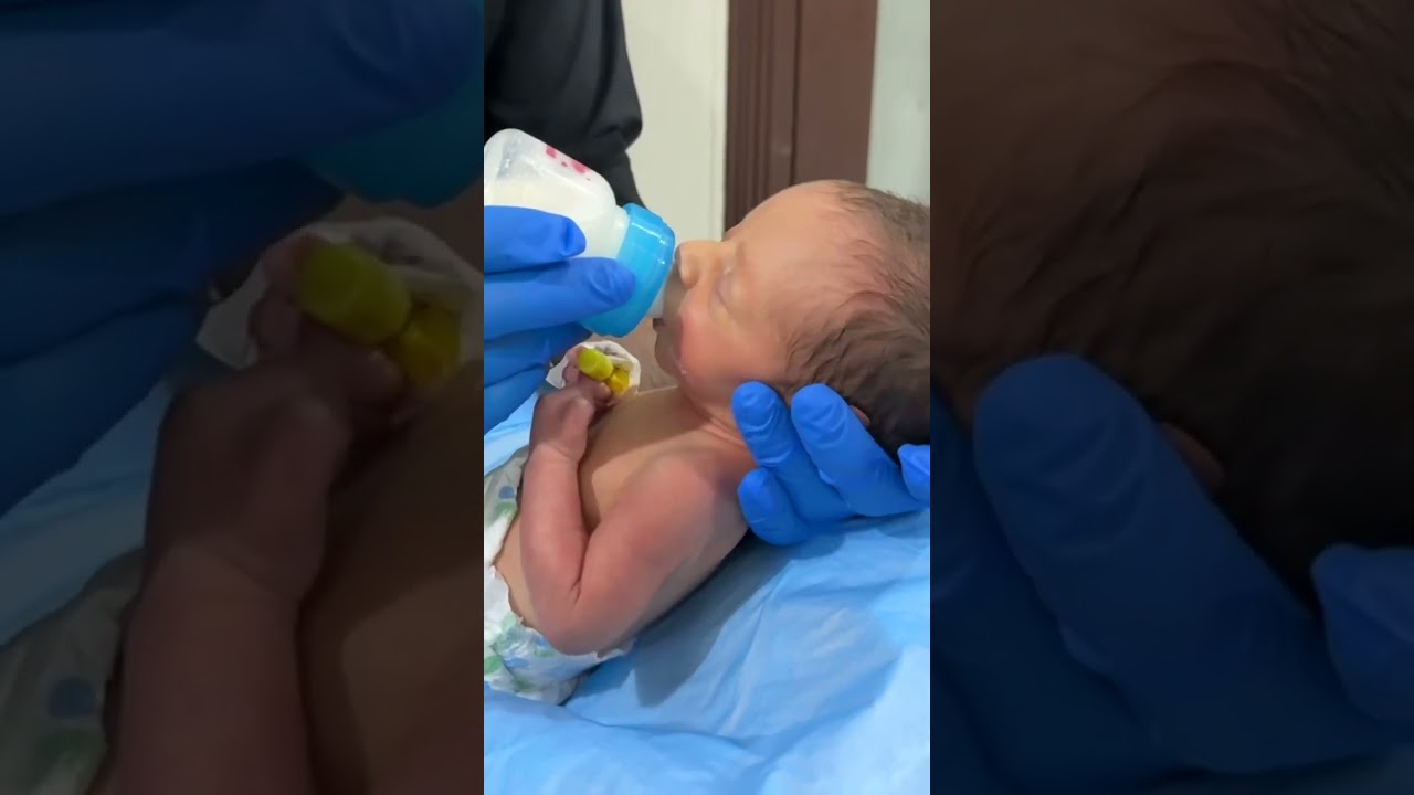 Hungry. Tiny. Cute baby bottle feeding 