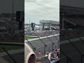 Indycars driving by turn 4 in a different angle