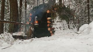 Building a Warm Winter Shelter. Winter camping in the forest. Campfire Steak