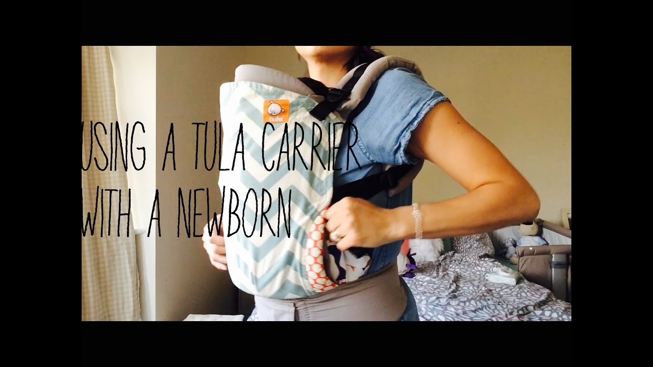 A TULA CARRIER WITH A NEWBORN 