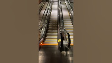 A Close Up View Of A Moving Escalator