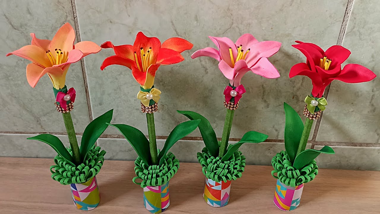 uma lembracinha para dia das mães caneta decorada com lírio  de E.V.A  e rolinho de  papel higienico