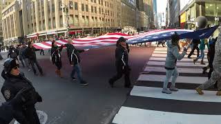 Giant US Flag sneaks up on Fox 5 news reporter during NYC Veteran's Day Parade