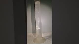 Alka-Seltzer Tablets dropped in a beaker of water in slow motion