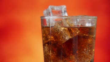 cola with ice cubes rotate close up cola with ice