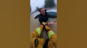 Firefighter Saves Man From Raging Floodwaters