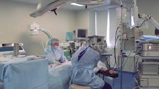 The Surgeon And Surgical Team Perform Cosmetic Surgery On The Breasts In A Hospital Operating Room