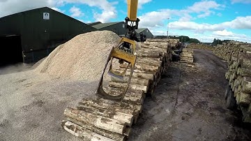 Powerhand GH Series log handling grapple operating in a sawmill