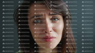 Close-up portrait of unhappy young woman crying feeling sad on dark background