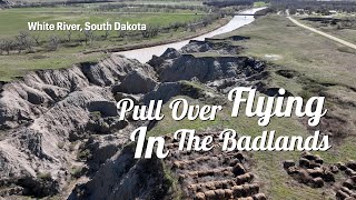 Pulled car over in Badlands to film White River, prairie and canyons on side of road in South Dakota