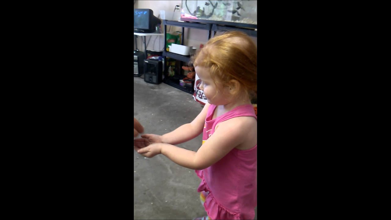 Little girl holding a baby tree frog