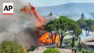 Aerial video shows a wildfire approaching homes in Spain