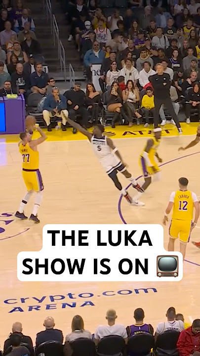 Luka Doncic hits a three from the logo