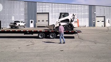 Finish Line Trailers unloading T300 Bobcat on Hydraulic Dove.