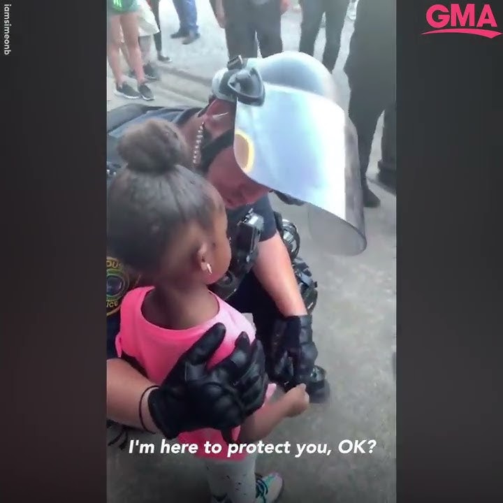 Police officer comforts little girl after she asks: 'Are you going to shoot us?' l GMA Digital