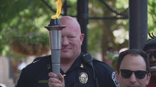 Law enforcement officials carry 'Flame of Hope' through Louisville for Special Olympics Kentucky