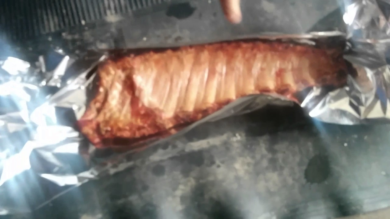 Adding apple juice and brown sugar to my ribs and back in the smoker