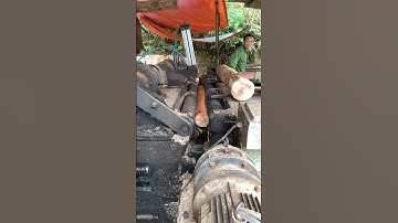 Close-up of peeling logs into thin planks