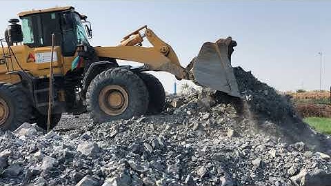 SDLG 965H Wheel Loader Loading MAN Truck Pushing Rock For Backfill On Construction Project.
