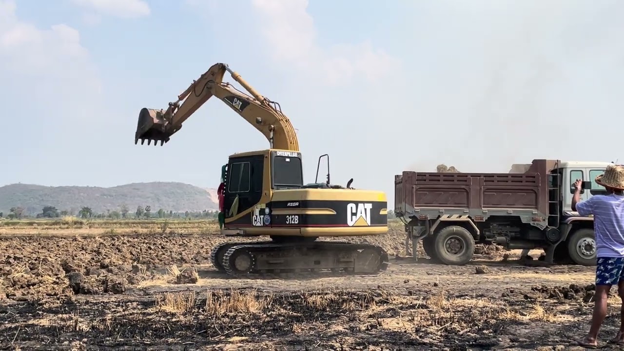 Excavator & Cat 352F With Hydr. Hammer Loading Stone Layers In Bell B50D - Ascon Ltd