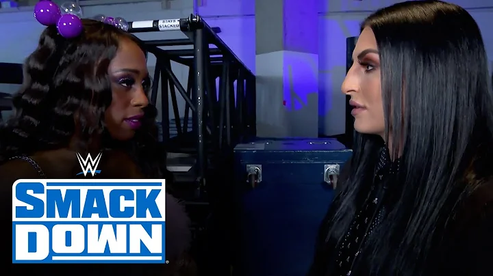 Naomi backs WWE Official Sonya Deville into a wall...