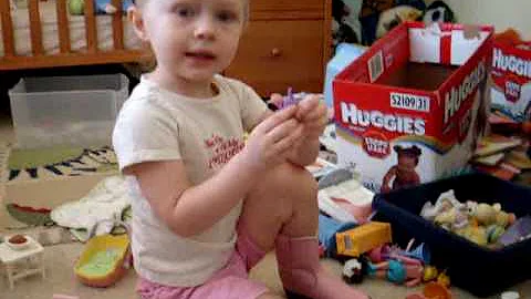 Toddler Zoe playing with doll house and animal toys