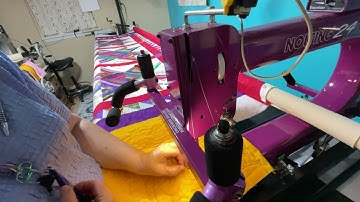 Changing a bobbin on a long arm quilting, machine, and testing the tension tutorial.