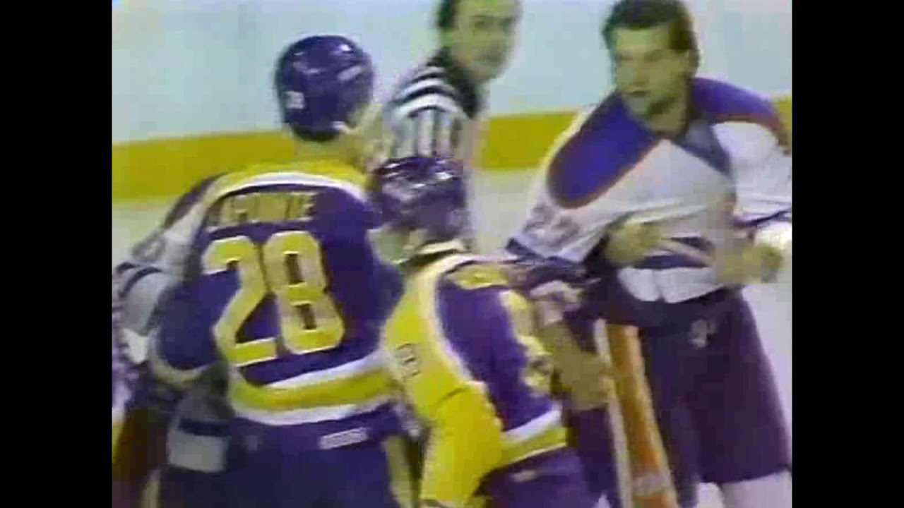 Kings' Rick Lapointe turtles under imminent threat of a Dave Semenko punch.