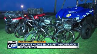 Lifeguards holding beach safety demonstration