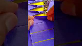 sewing and creating beautiful purple fabric patterns using a sewing machine for a clothing design