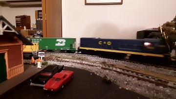 CSX C40-9W and U30C make their way by the railroad park on my HO scale layout with a manifest