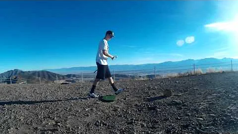 Hitting golf balls off the top of the mountain